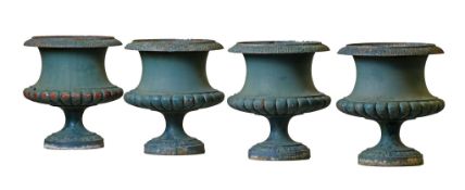 A set of four Continental green painted cast iron garden urns  A set of four Continental green