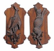 A pair of Continental, probably German or Swiss carved and stained wood wall...  A pair of