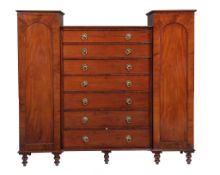 A flame mahogany triple section compactum wardrobe , first half 19th century  A flame mahogany