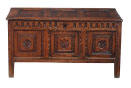 A Charles II oak coffer, circa 1660, the rectangular triple panel lid  A Charles II oak coffer,