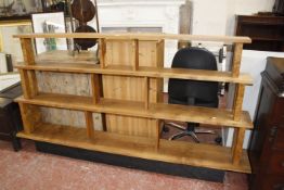 A set of contemporary graduated shelves, English brown oak, uprights of burr oak, on a base of