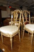 A pair of 19th century French giltwood salon chairs and another single giltwood chair.