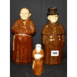 A Royal Worcester monk candlesnuffer, 12cm high, and two ceramic decanters, a coachman marked 8301