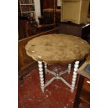 A white painted table on bobbin turned legs and brown velvet table cover.
