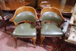 A pair of 20th Century Continental style mahogany and upholstered tub chairs