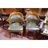 A pair of 20th Century Continental style mahogany and upholstered tub chairs