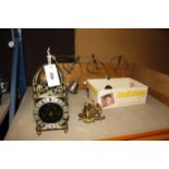 A modern brass lantern clock, two modern Dutch style wall clocks, a wall mounted set of bells and