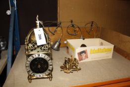 A modern brass lantern clock, two modern Dutch style wall clocks, a wall mounted set of bells and