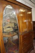An Edwardian mahogany and inlaid bedroom suite to include a compactum, dressing table with two short