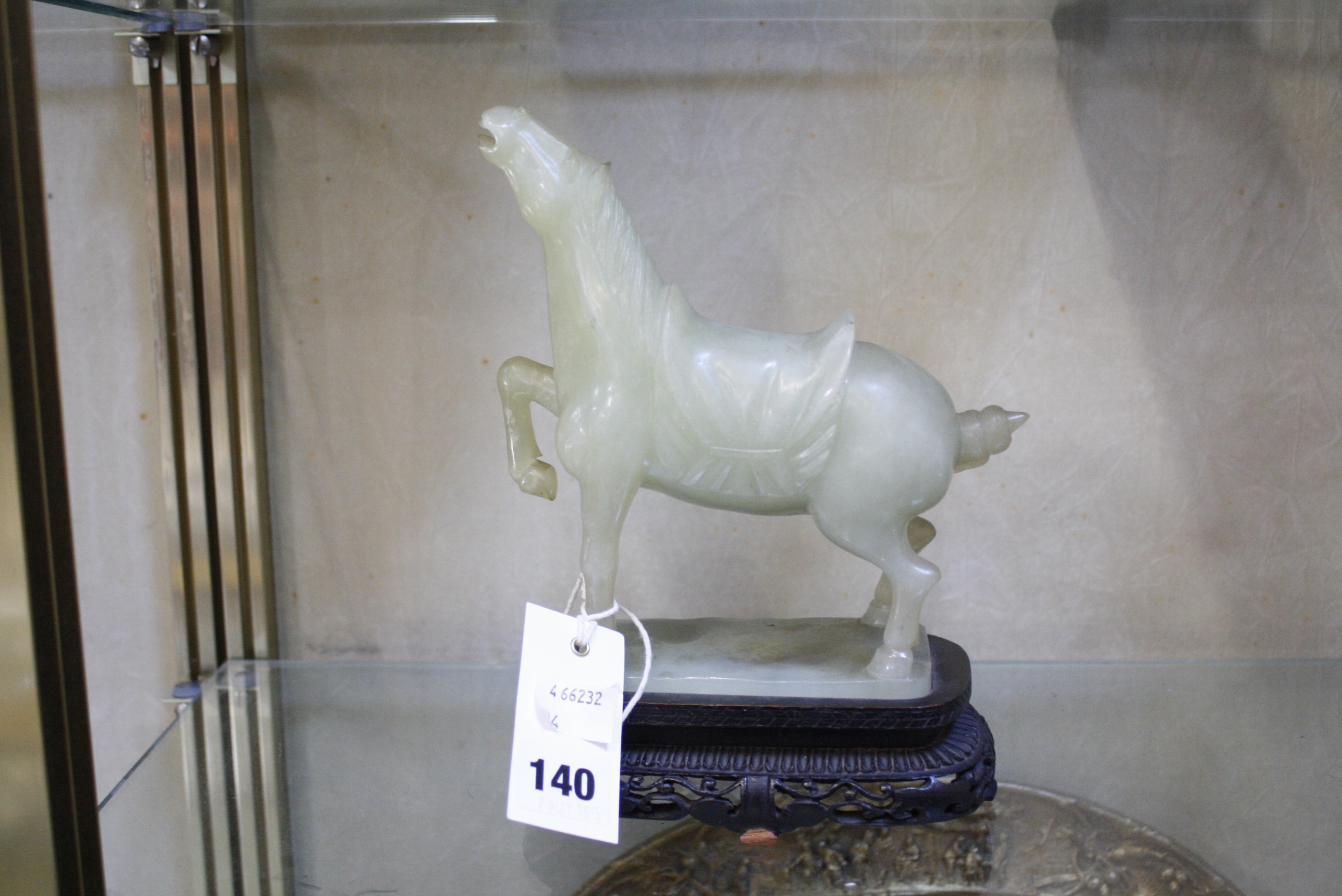 A 20th Century jade horse on carved wooden stand, 22cm high