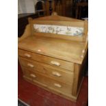 A Victorian pine wash stand with tiled splash back. 102cm wide x 51cm deep x 117cm high.