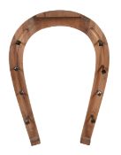 A stained wood coat rack, 20th century, in the form of horseshoe with lacquered brass nail pattern