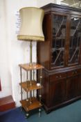 A Victorian brass and walnut three tier standard lamp.