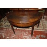 A 19th century mahogany demilune table.
