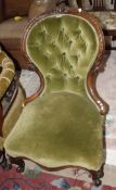 A Victorian carved walnut button back salon chair.