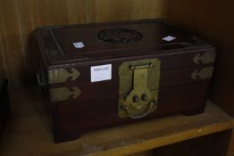 An Oriental hardwood chest of eight drawers, enclosing sewing items, 26cm wide, an Oriental