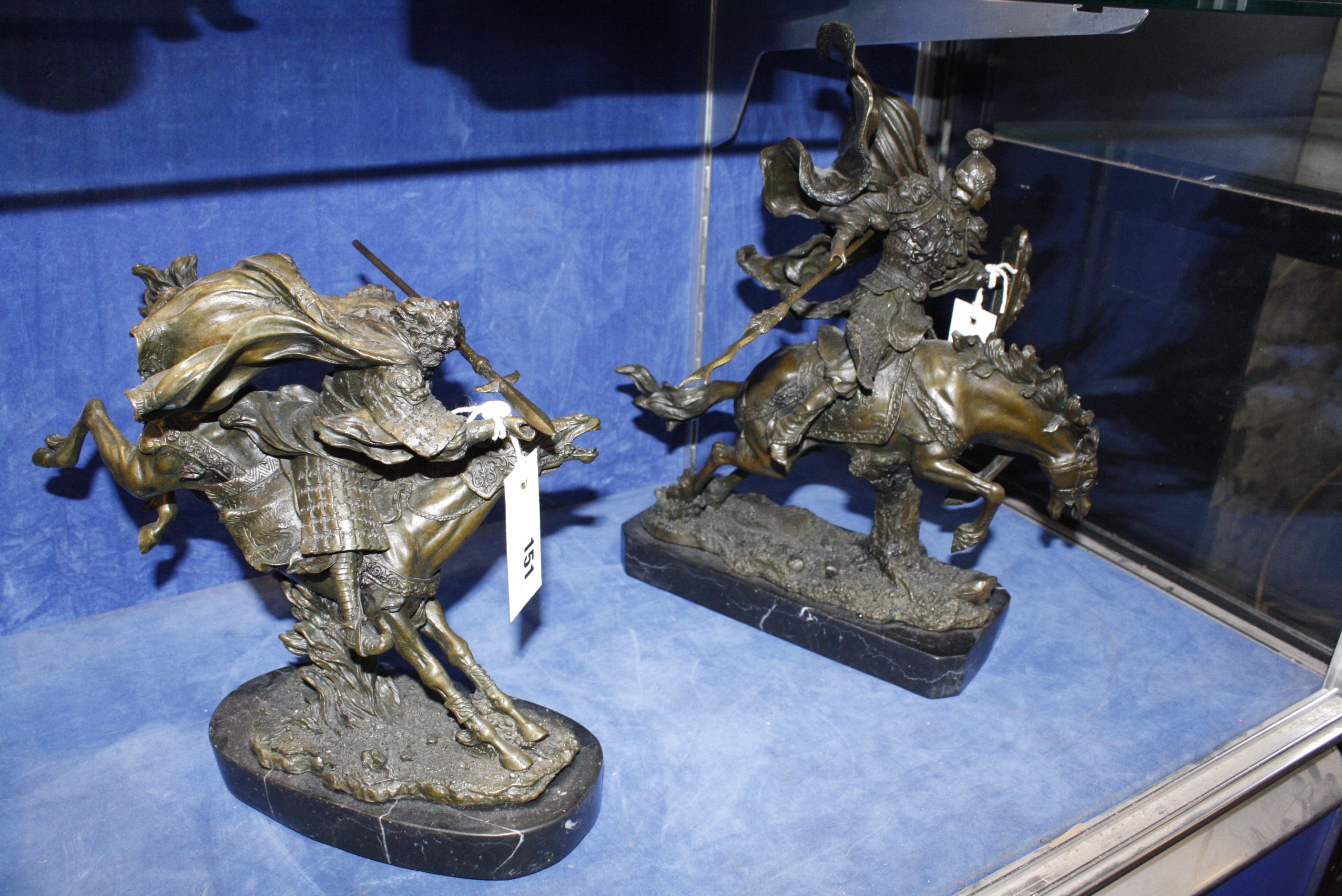 A pair of modern bronze figures of warriors on horseback, 27cm and 37cm high approx. (2)