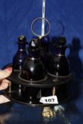 A set of four Georgian English blue glass mallet form condiment bottles with assorted stoppers
