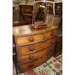 A 19th Century bow front chest of drawers 107cm wide, and vanity mirror.
