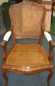 * An oak Louis XV style caned open armchair.  Best Bid