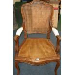 * An oak Louis XV style caned open armchair.  Best Bid