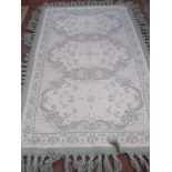 A modern green ground machine made rug 167 x 99cm