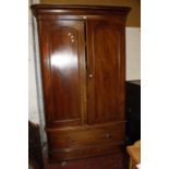 A Victorian mahogany wardrobe with a fitted interior of drawers and shelves,arch panelled doors over