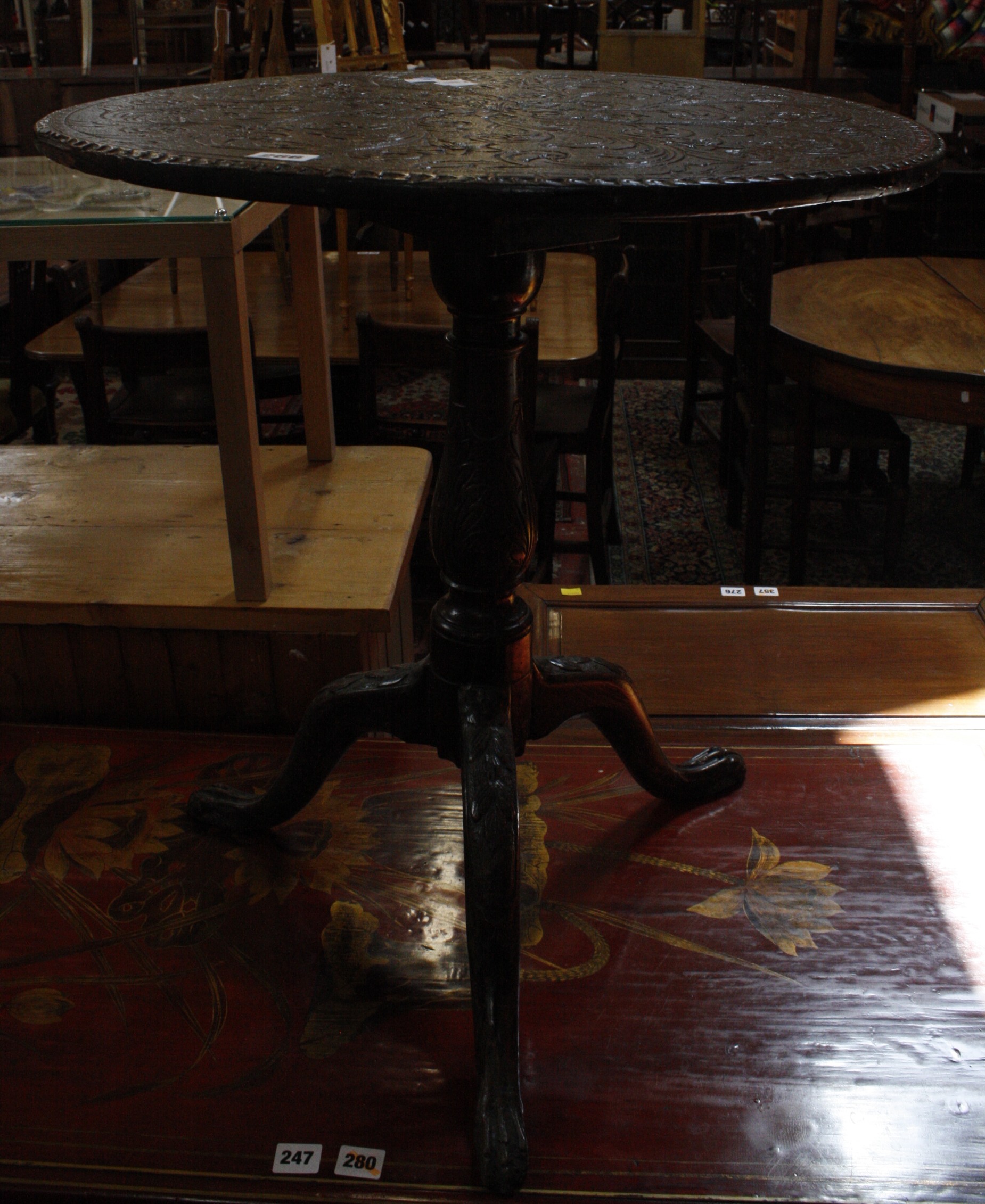 A George II oak tripod table,with a  later foliate carved top.