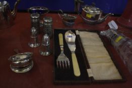 A quantity of plated ware to include a claret jug, a pair candlesticks, fish servers etc