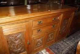 An Edwardian walnut Aesthetic design sideboard with drawers over a cabinet. 183cm wide.