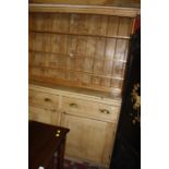 A pine dresser, with enclosed plate rack with a base of two drawers and cupboard. 157cm wide x 201cm