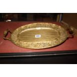 A late 19th century gilt copper electrotype twin handled oval dish, probably German, 42cm wide