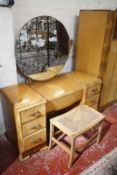An Art Deco bedroom suite, comprising a wardrobe 187cm high, 118cm wide, a dressing table with