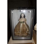 A wax head doll in Victorian dress, in wooden and glazed display case, 68cm x 46cm