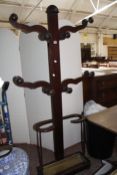 An early Victorian mahogany coat stand with four shaped arms and umbrella stand with brass drip tray