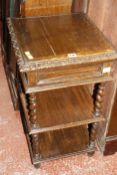 A late Victorian three tier carved oak whatnot