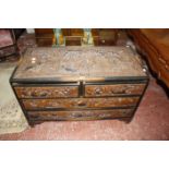 A Chinese heavily carved camphor wood chest of  drawers , two drawers over two long.