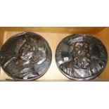 A circular patinated metal portrait plaque of Christopher Columbus and another of Vasco da Gama,