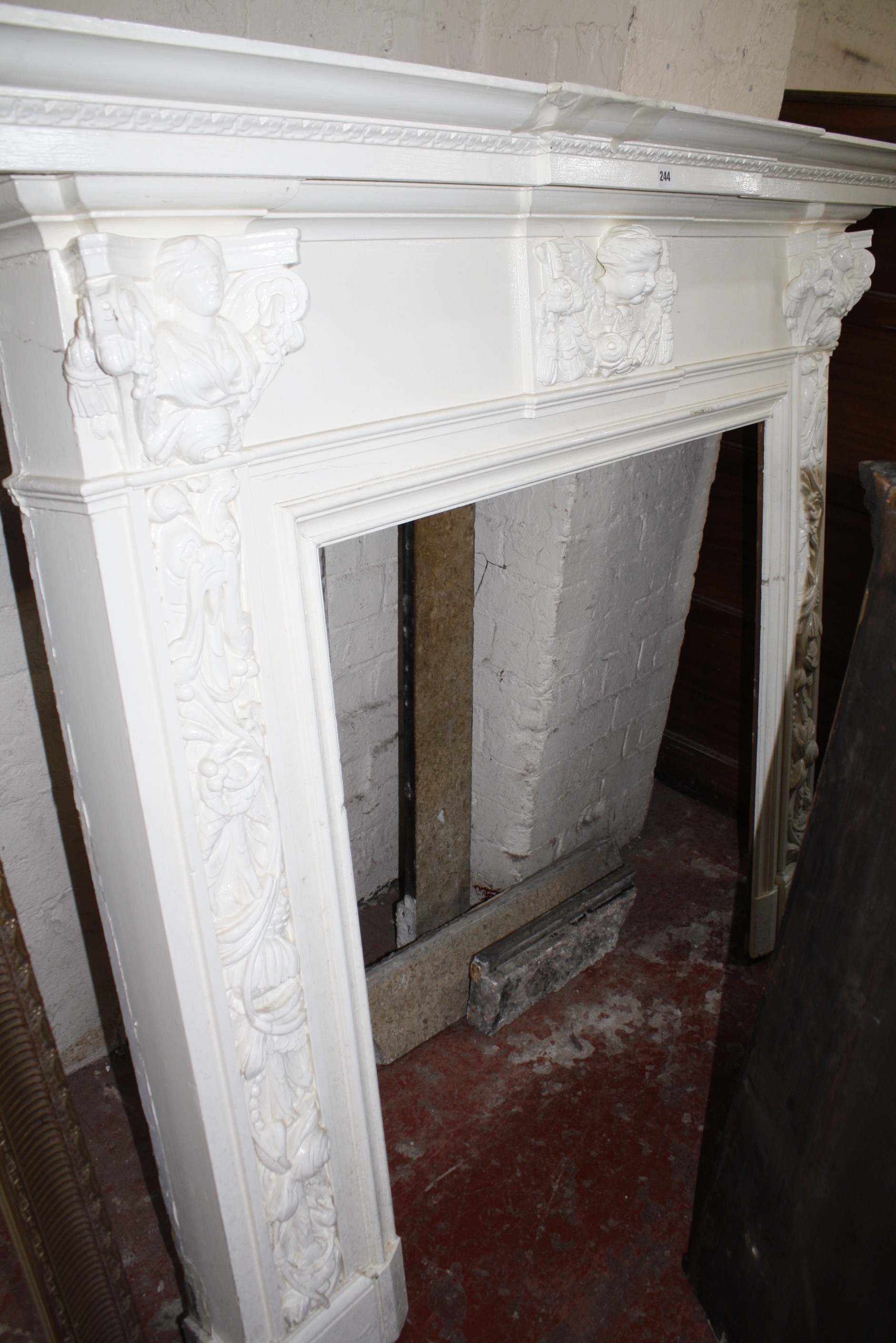 A carved wood fire surround with accompanying marble (three pieces) 135cm high 164cm wide