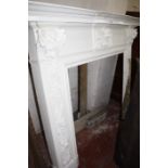 A carved wood fire surround with accompanying marble (three pieces) 135cm high 164cm wide