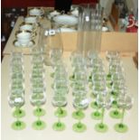 Two modern clear glass vases and a quantity of green stemmed hock glasses, plus a Dartington glass