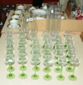 Two modern clear glass vases and a quantity of green stemmed hock glasses, plus a Dartington glass