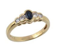 A sapphire and diamond ring, the central oval shaped sapphire set between...  A sapphire and diamond