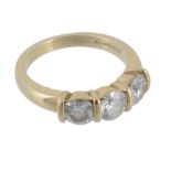 An 18 carat gold diamond three stone ring  An 18 carat gold diamond three stone ring,   set with