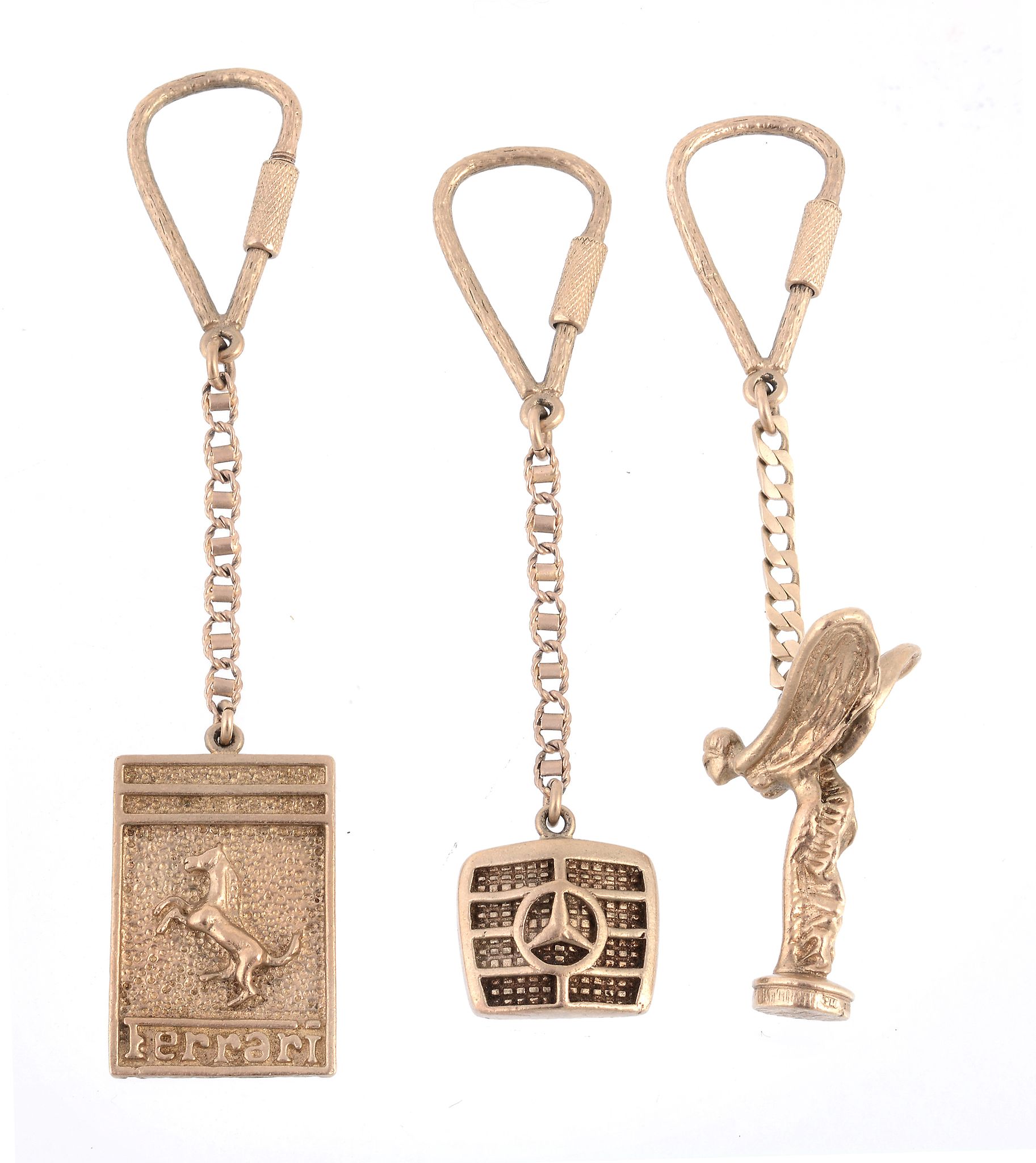 Three 9 carat gold key fobs , two in the form of car badges  Three 9 carat gold key fobs  , two in