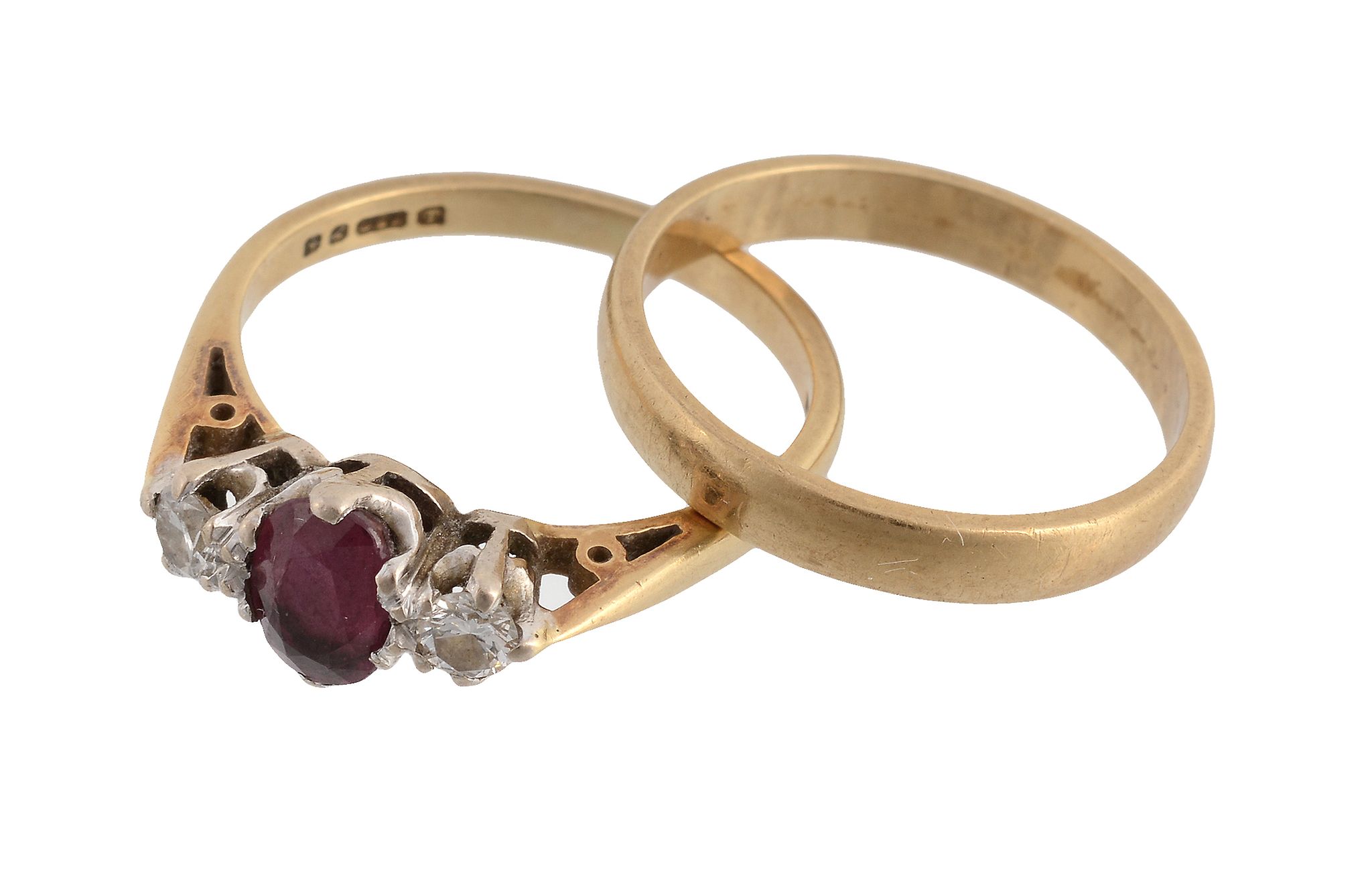 A ruby and diamond three stone ring , the oval cut ruby between two...  A ruby and diamond three