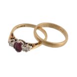 A ruby and diamond three stone ring , the oval cut ruby between two...  A ruby and diamond three