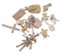A small collection of charms, to include a camel; a tennis racket; Tutankhamun  A small collection