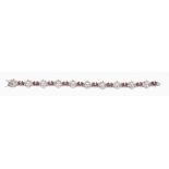 A ruby and diamond bracelet, the articulated bracelet composed of foliate...  A ruby and diamond