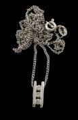 A three stone diamond bar pendant, the brilliant cut diamonds in a channel...  A three stone diamond